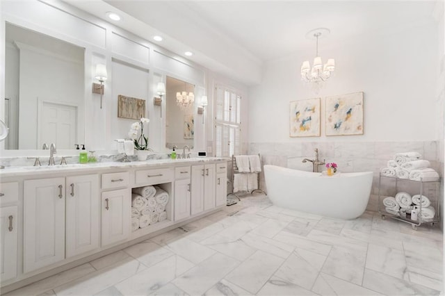 bathroom with double vanity, tile walls, a notable chandelier, and tile patterned floors