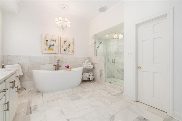 bathroom with tile walls, tile patterned floors, a notable chandelier, and vanity