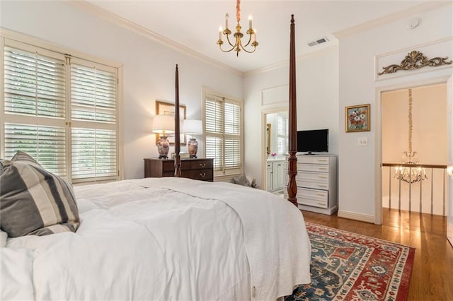 bedroom with an inviting chandelier, wood-type flooring, and crown molding