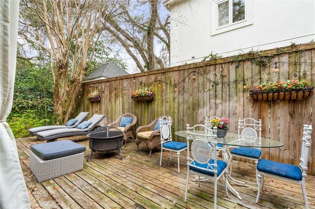 wooden deck featuring a fire pit