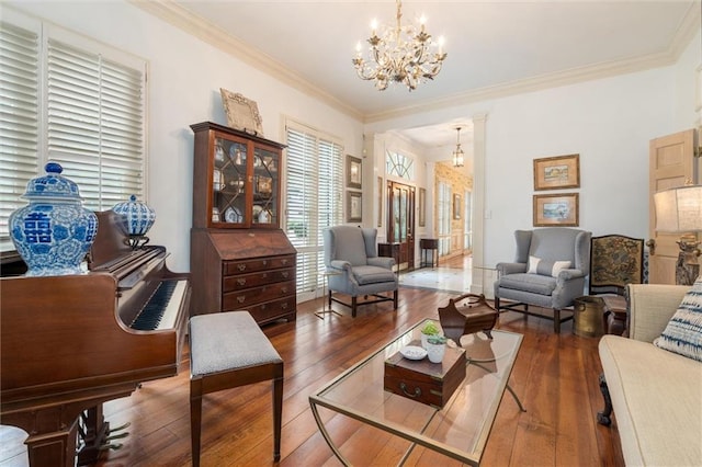 living room featuring a chandelier, crown molding, and dark wood-type flooring