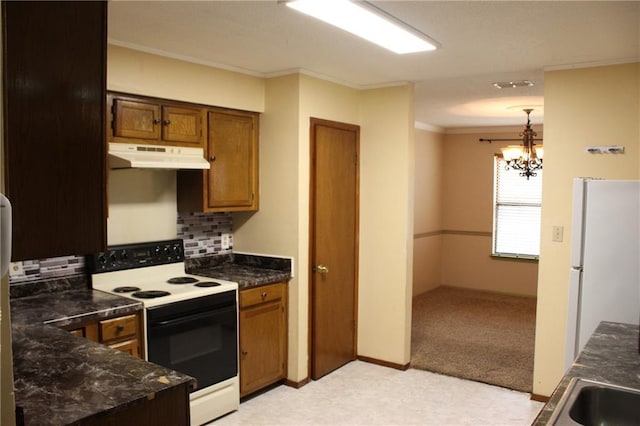 6500 Camden Cir, Mobile, AL 36618 - kitchen with white appliances, under cabinet range hood, ornamental molding, decorative backsplash, and a chandelier