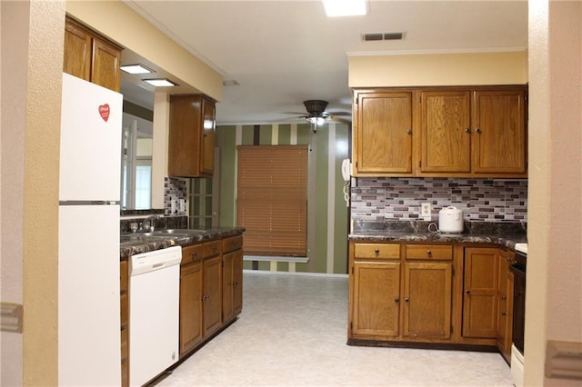 6500 Camden Cir, Mobile, AL 36618 - kitchen with white appliances, a ceiling fan, tasteful backsplash, and dark countertops