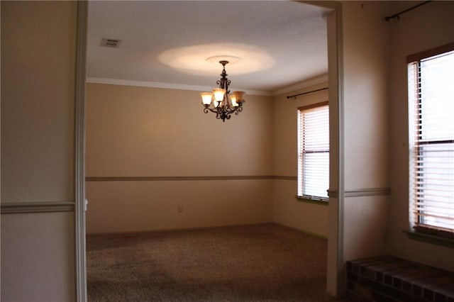 6500 Camden Cir, Mobile, AL 36618 - carpeted spare room featuring a chandelier, ornamental molding, and plenty of natural light