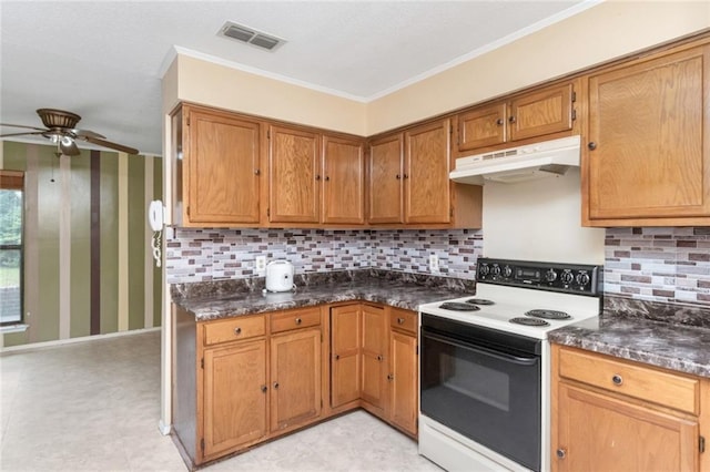 6500 Camden Cir, Mobile, AL 36618 - kitchen with range with electric cooktop, under cabinet range hood, dark countertops, ceiling fan, and crown molding