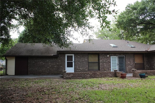 6500 Camden Cir, Mobile, AL 36618 - rear view of house with brick siding, a patio area, roof with shingles, and a lawn