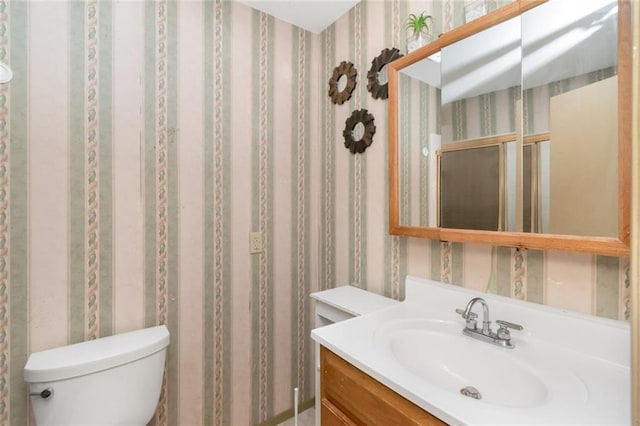 6500 Camden Cir, Mobile, AL 36618 - bathroom featuring toilet, vanity, and wallpapered walls
