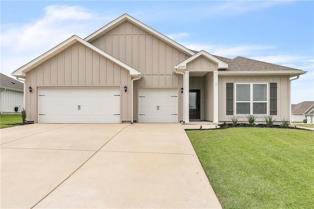 view of front of house with a garage, concrete driveway, a front lawn, roof with shingles, and board and batten siding