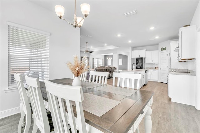 dining space with light wood-style floors, recessed lighting, a chandelier, baseboards, and ceiling fan