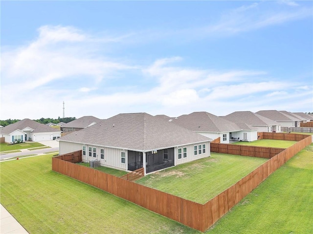 rear view of house with a sunroom, roof with shingles, and a residential view