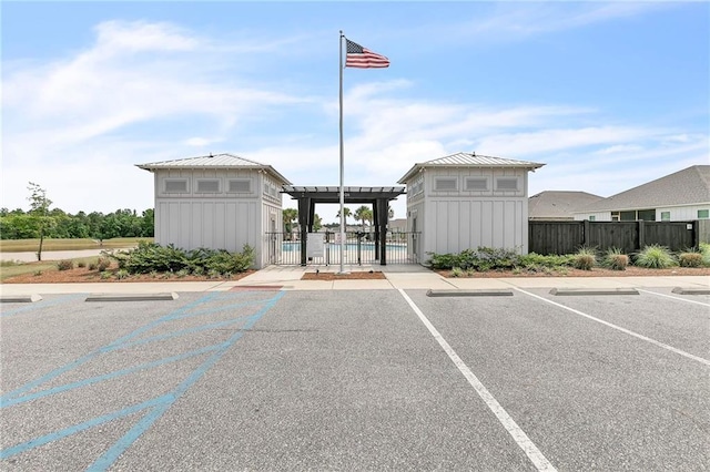 uncovered parking lot with a gate and fence