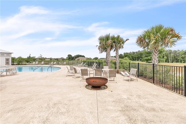 community pool featuring a patio area and fence