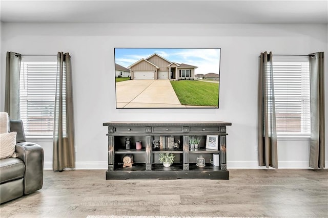 living area with wood finished floors and baseboards