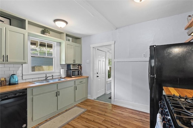 1704 Laurel St, Mobile, AL 36604 - kitchen with black appliances, tasteful backsplash, light wood-style floors, wooden counters, and open shelves