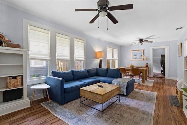 1704 Laurel St, Mobile, AL 36604 - living room featuring ceiling fan, wood finished floors, and crown molding