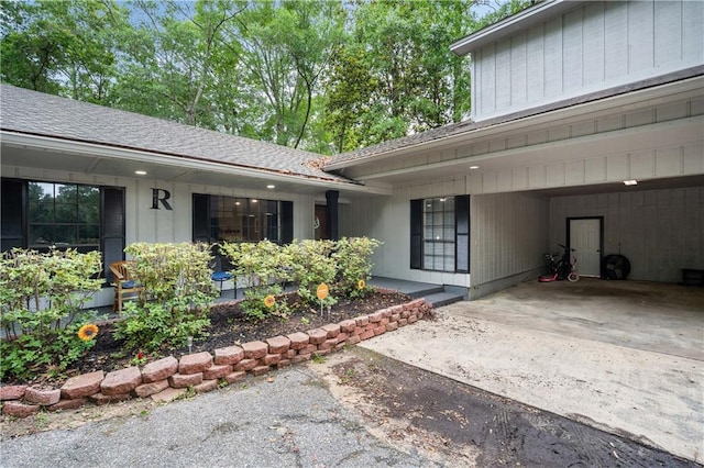 2017 Knollwood Dr, Mobile, AL 36609 - property entrance with driveway, a carport, and roof with shingles
