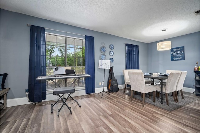 2017 Knollwood Dr, Mobile, AL 36609 - dining space featuring a textured ceiling, wood finished floors, and baseboards