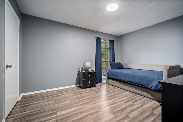 2017 Knollwood Dr, Mobile, AL 36609 - bedroom featuring wood finished floors, a textured ceiling, and baseboards