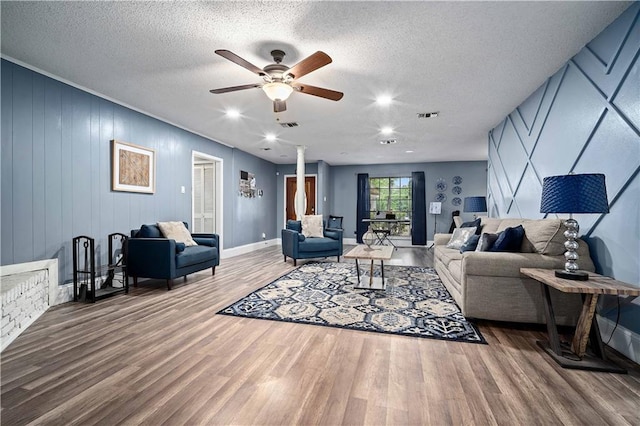 2017 Knollwood Dr, Mobile, AL 36609 - living room with wood finished floors, ceiling fan, baseboards, and a textured ceiling