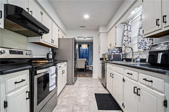 2017 Knollwood Dr, Mobile, AL 36609 - kitchen with stainless steel appliances, under cabinet range hood, a sink, dark countertops, and white cabinets