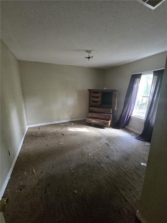 unfurnished bedroom with a textured ceiling