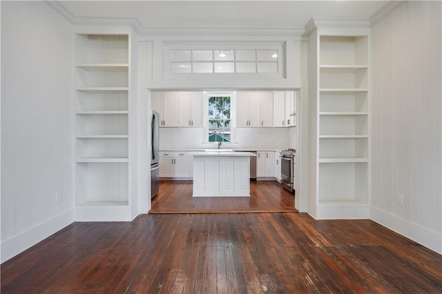 kitchen with appliances with stainless steel finishes, a center island, white cabinets, and dark hardwood / wood-style flooring