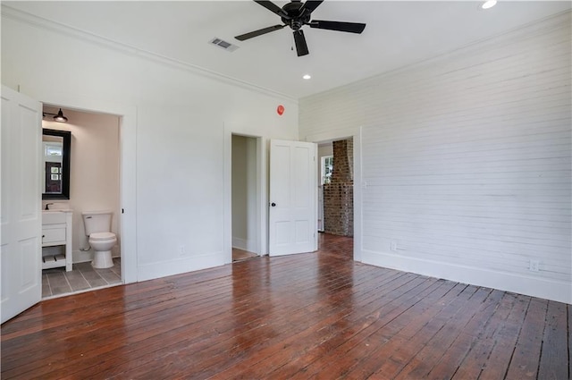 unfurnished bedroom featuring ceiling fan, ensuite bath, ornamental molding, and dark hardwood / wood-style flooring