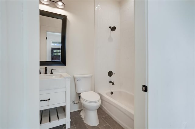 full bathroom featuring vanity, tiled shower / bath combo, and toilet