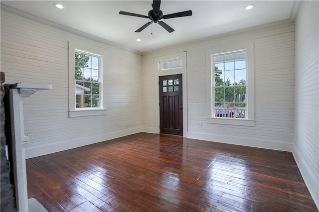 entryway with crown molding, dark hardwood / wood-style floors, a wealth of natural light, and ceiling fan