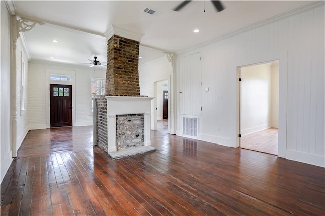 unfurnished living room featuring ceiling fan, ornamental molding, dark hardwood / wood-style floors, and a brick fireplace