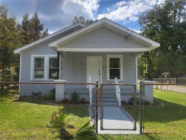 bungalow with covered porch and a front yard