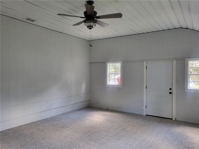 carpeted spare room featuring wood ceiling, lofted ceiling, ceiling fan, and plenty of natural light