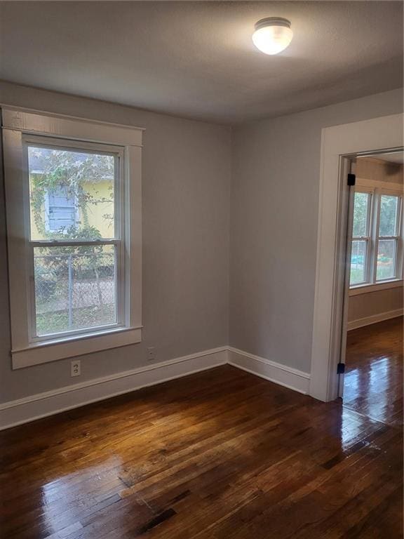 spare room with dark hardwood / wood-style flooring