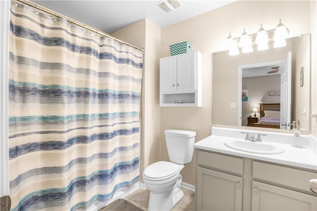 bathroom featuring walk in shower, tile patterned flooring, vanity, and toilet