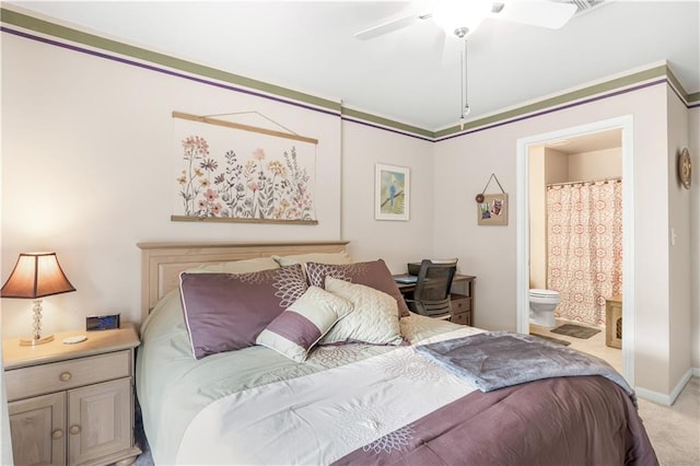 bedroom featuring light carpet, ensuite bath, and ceiling fan