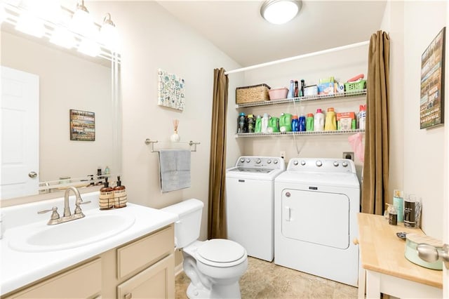 bathroom featuring vanity, toilet, and washing machine and clothes dryer