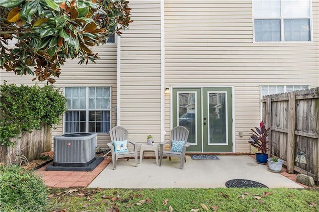 back of house with cooling unit and a patio