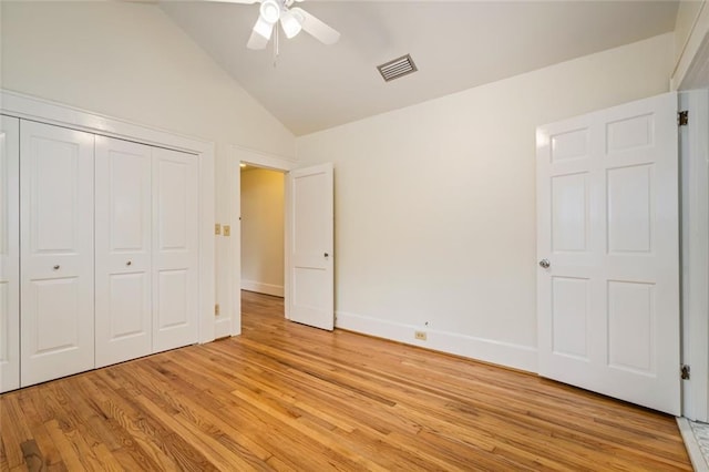 unfurnished bedroom featuring vaulted ceiling, ceiling fan, light hardwood / wood-style floors, and a closet