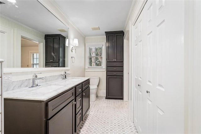 bathroom featuring ornamental molding, vanity, and toilet