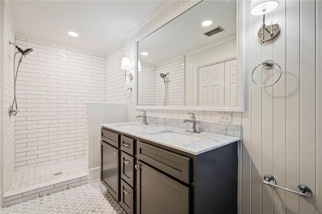 bathroom featuring vanity and tiled shower