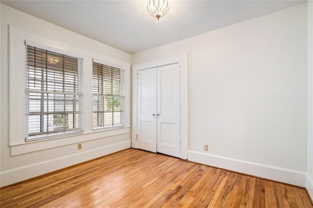 unfurnished bedroom featuring a closet and light hardwood / wood-style flooring