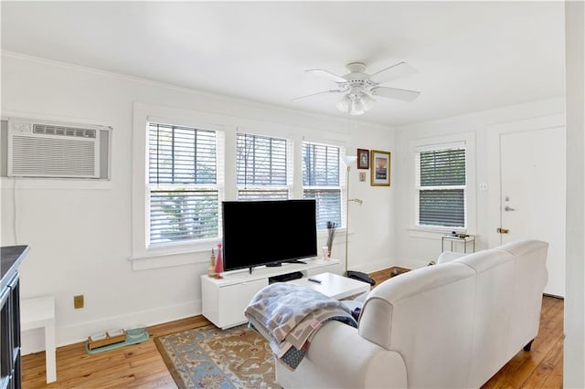 living room with hardwood / wood-style flooring, ceiling fan, a wall mounted air conditioner, and crown molding