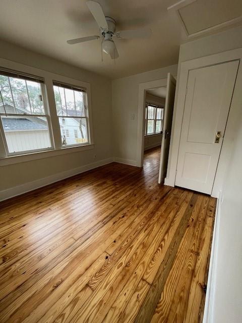 empty room with light hardwood / wood-style floors and ceiling fan