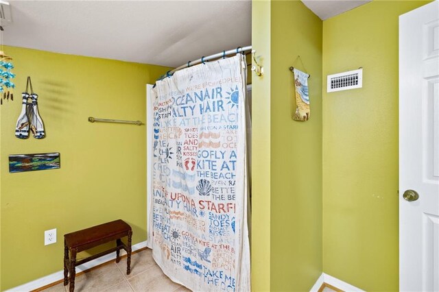 bathroom featuring tile patterned flooring and walk in shower