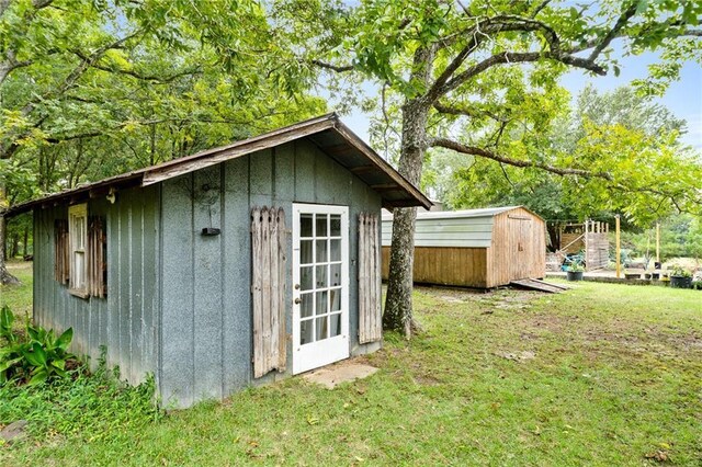 view of outbuilding featuring a yard