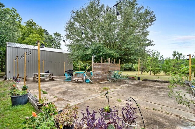 view of patio / terrace featuring an outbuilding