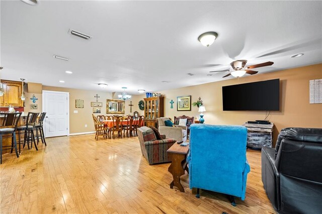 living room with hardwood / wood-style floors and ceiling fan