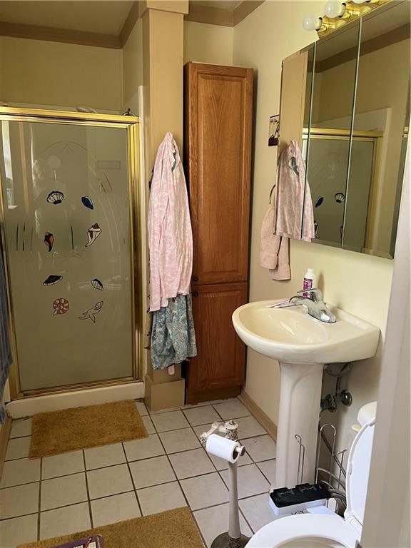 2618 Diberville Dr N, Mobile, AL 36695 - bathroom with a shower stall, tile patterned floors, and toilet