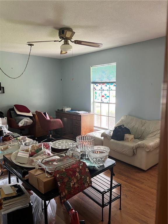 2618 Diberville Dr N, Mobile, AL 36695 - dining area with a ceiling fan, wood finished floors, and a textured ceiling