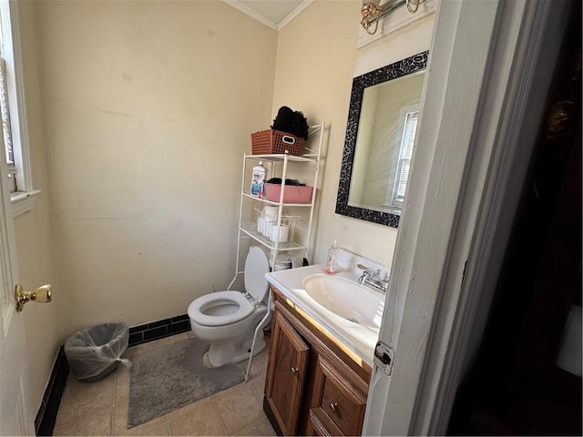 bathroom with toilet, vanity, and tile patterned flooring